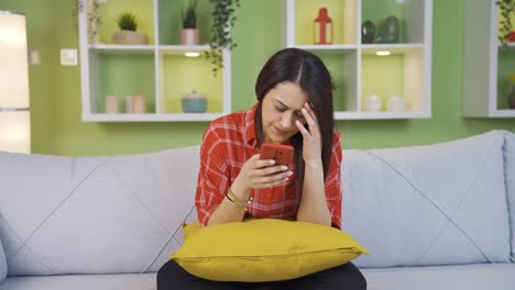 Young-woman-using-phone-is-depressed-and-sad.
